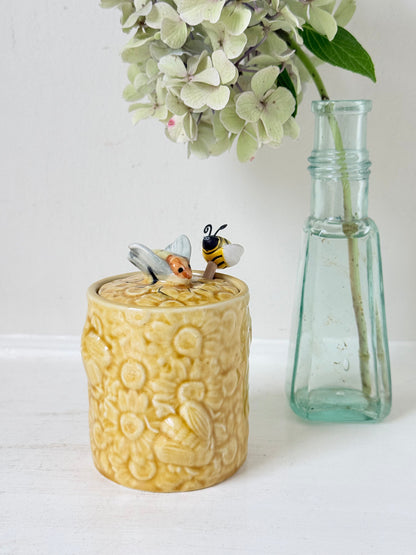 Secla pottery honey jar with lid, bee motif, and wooden honey spoon, made in Portugal, photographed on a white surface