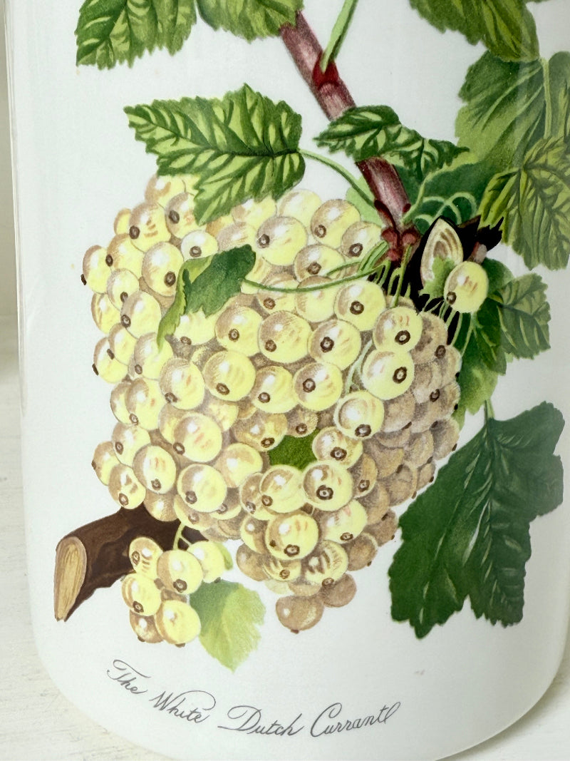 Vintage Portmeirion Botanic Garden ceramic canister with wooden lid and hydrangea design photographed on a white surface.