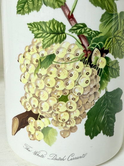 Vintage Portmeirion Botanic Garden ceramic canister with wooden lid and hydrangea design photographed on a white surface.