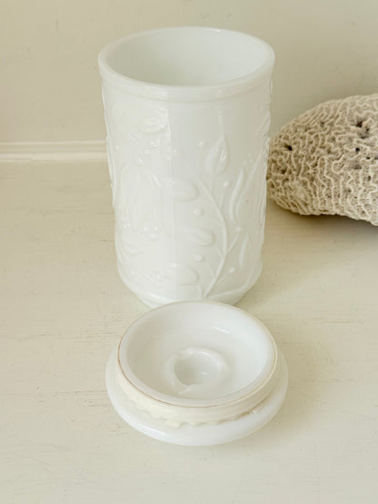 French opale glass jar with floral raised design, white vintage milk glass, shown on white background