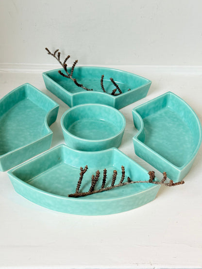 Poole Pottery turquoise hors d’oeuvre dishes set of five displayed on a white surface.