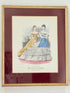 Vintage Modes de Paris fashion plate with gilt frame and burgundy mount, photographed on white surface