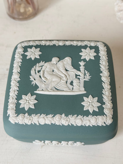 Vintage Wedgwood Jasperware teal green square lidded trinket box, decorated with white neoclassical figures and florets, styled with dried stems.