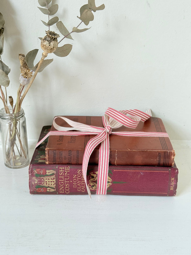 Vintage book bundle of English Costume and History of England with burgundy and brown hardback covers, photographed on a white surface