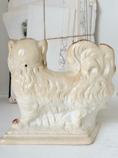Pair of antique standing Staffordshire Pekingese dogs in rust red and white with blue painted bows