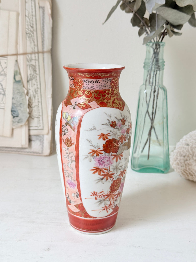 Japanese Kutani porcelain vase hand painted with flowers in white panels on an iron red and gold ground