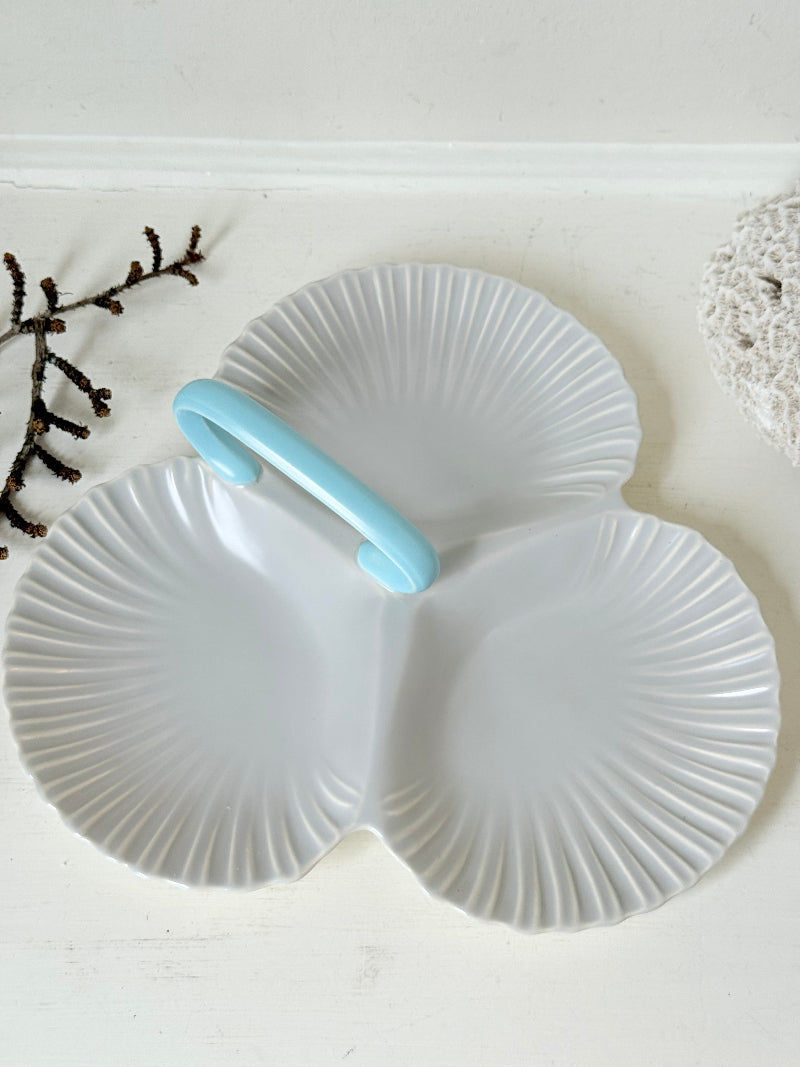 Poole Pottery triple scallop hors d’oeuvre dish in grey glaze with powder blue handle photographed on a white surface