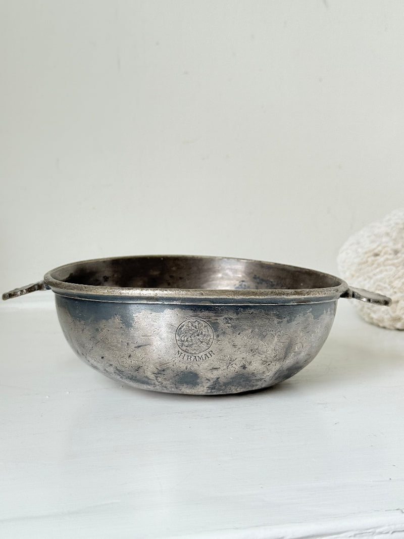 Antique Christofle silver plate bowl with decorative handle, photographed on a white surface.