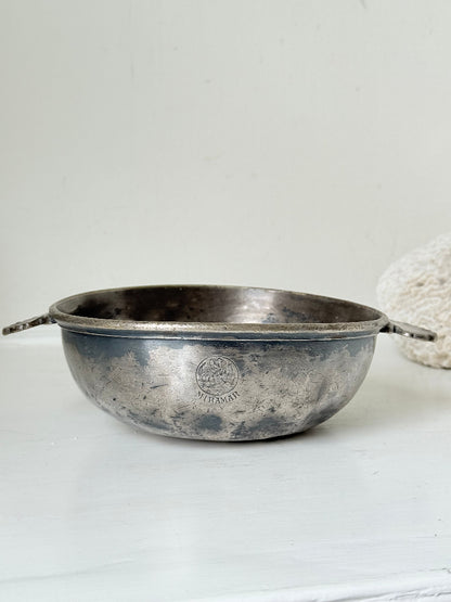 Antique Christofle silver plate bowl with decorative handle, photographed on a white surface.