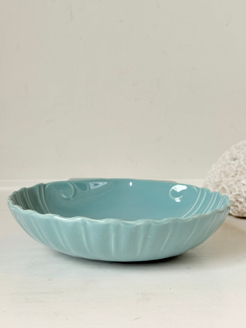 Poole Pottery scallop shell serving dish in sea blue glaze photographed on a white surface
