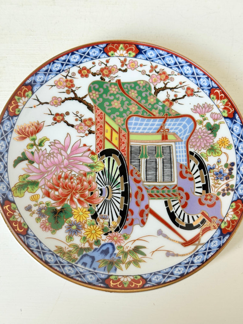 Set of 3 vintage East Asian style decorative hanging plates with peacock and floral design photographed on a white surface