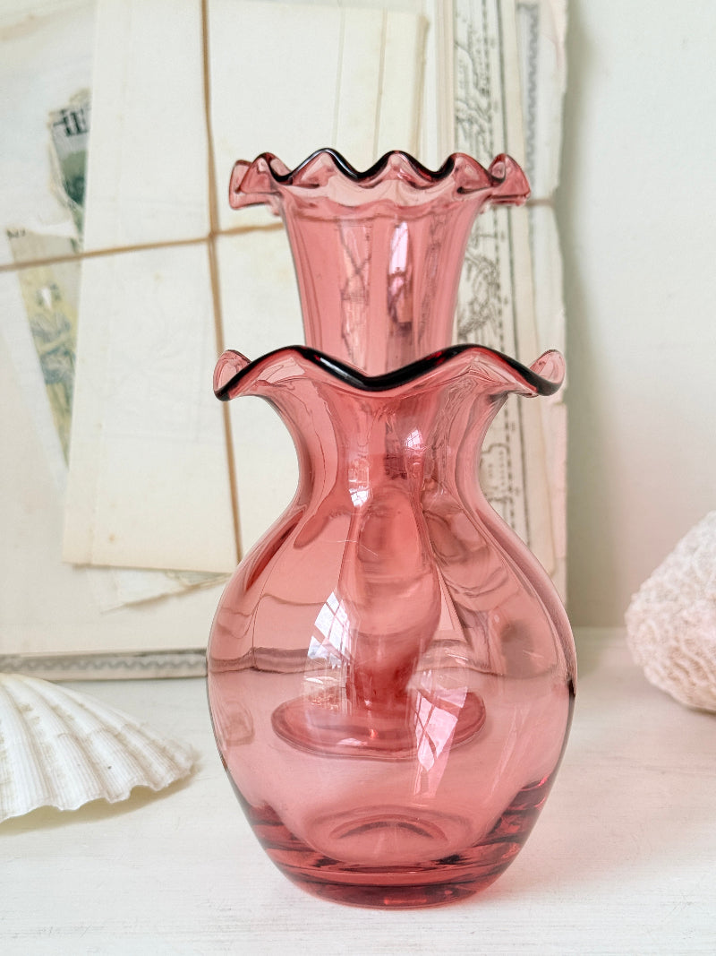 Pair of cranberry glass vases with crimped frill rims, trumpet vase and bulbous bud vase in soft pink glass