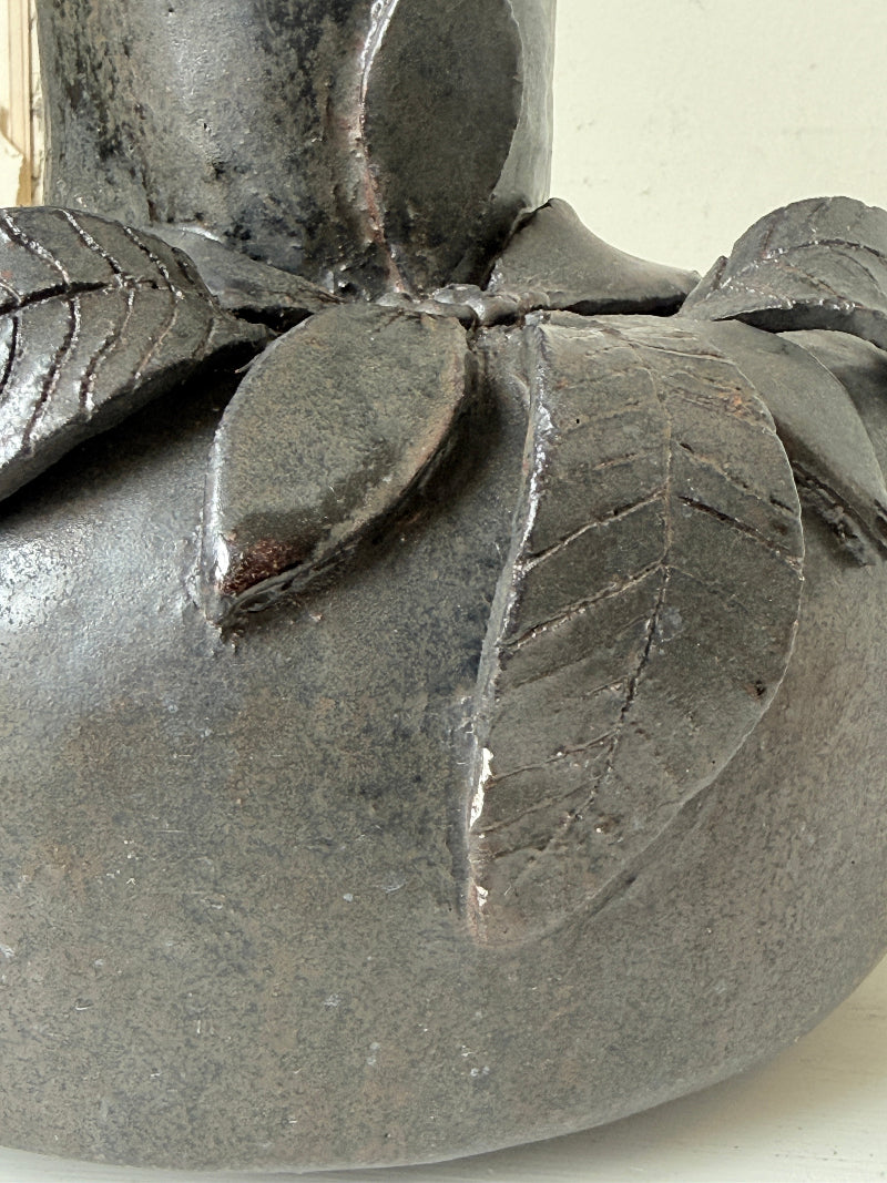 Studio pottery ceramic vase with liquorice grey glaze, applied floral and leaf detail and rounded handmade form