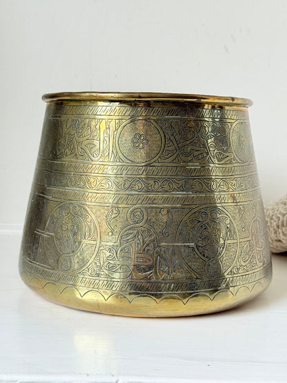 Large vintage brass pot with engraved decoration and aged patina, photographed on a white surface