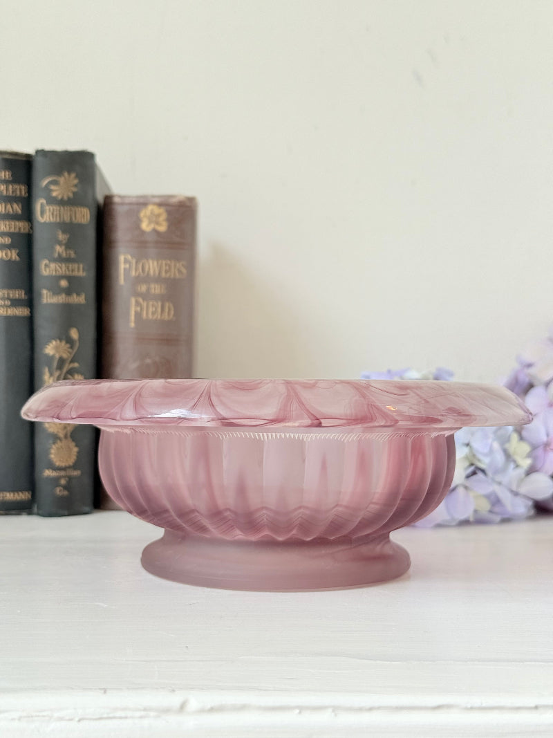 Davidson Cloud Glass bowl in amethyst with swirl pattern and footed base, styled with books and hydrangeas