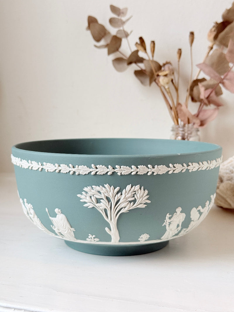 Large vintage Wedgwood Jasperware teal green fruit bowl decorated with white classical figures beneath stylised trees and a laurel garland border.