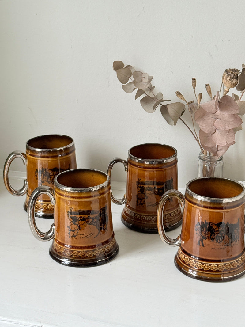 Set of 4 antique Ridgway stoneware beer tankards photographed on a white surface in amber treacle glaze with black Coaching Days and Coaching Ways scenes