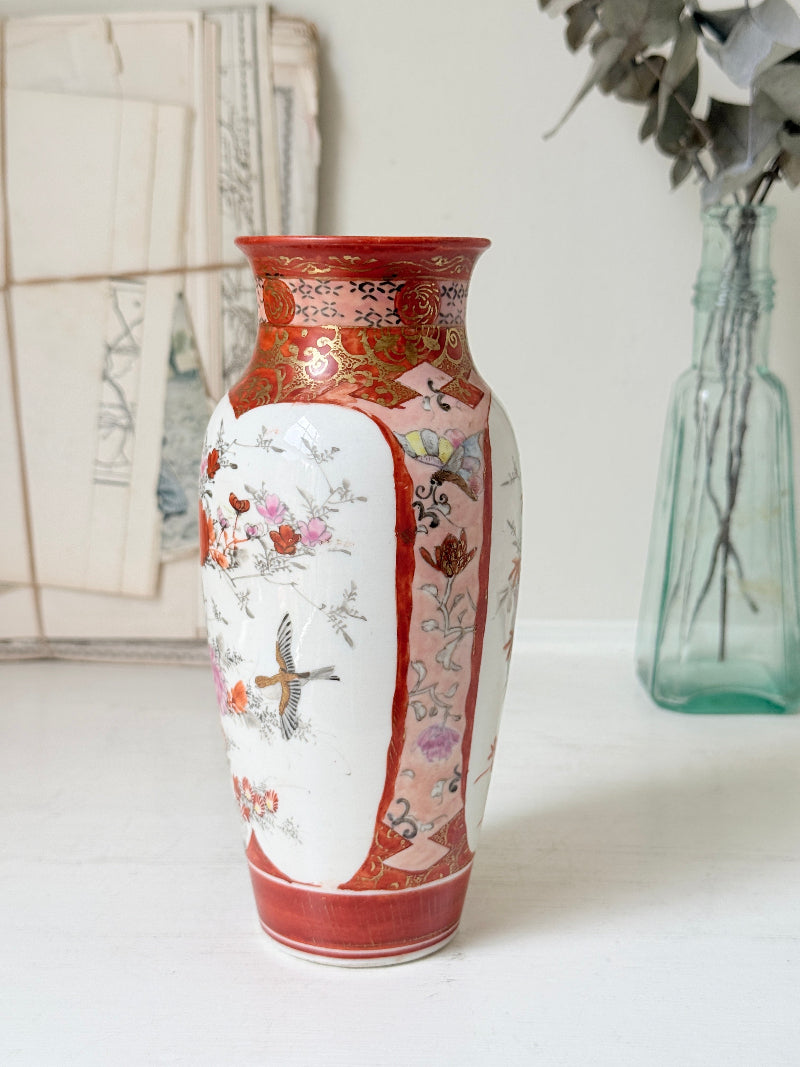 Japanese Kutani porcelain vase hand painted with flowers in white panels on an iron red and gold ground