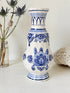 Vintage Delft style blue and white pottery vase with hand painted floral decoration, photographed on a white surface