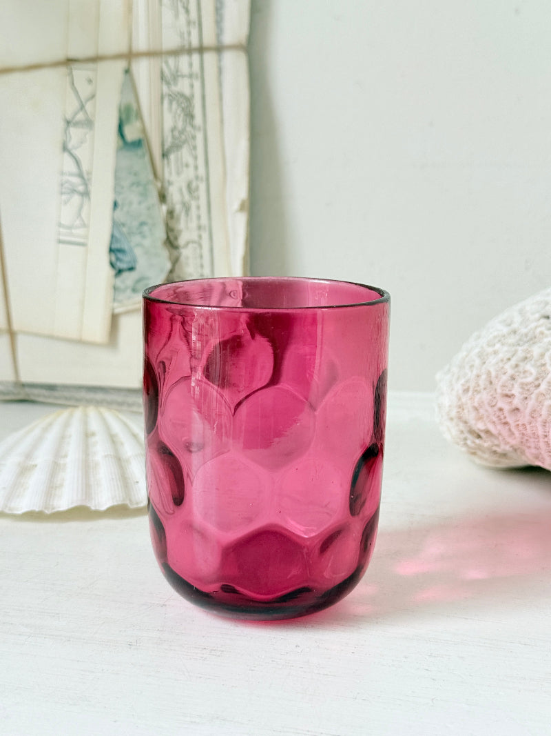 Vintage cranberry glass beaker with honeycomb optic pattern, deep pink colour and textured moulded glass for shelf styling