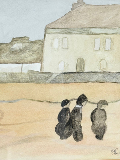 Framed neutral-toned village scene watercolour with figures in light oak-effect frame and pale grey mount, on white surface.