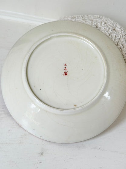 Japanese Kutani porcelain dish hand painted with a garden pavilion scene in iron red and gold
