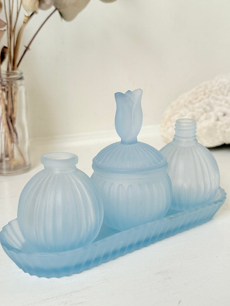 Vintage powder blue frosted glass dresser set with tray and three matching pieces, photographed on a white surface