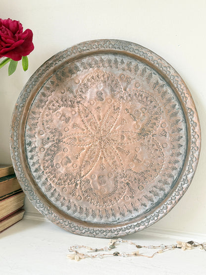 Vintage hand engraved copper tray with sunburst centre, decorative border and aged verdigris patina for wall or tabletop styling