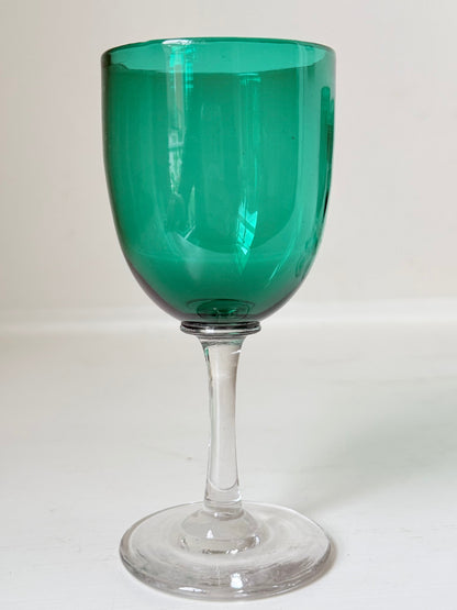 Antique set of four Bristol green liqueur glasses with clear stems, photographed on a white surface