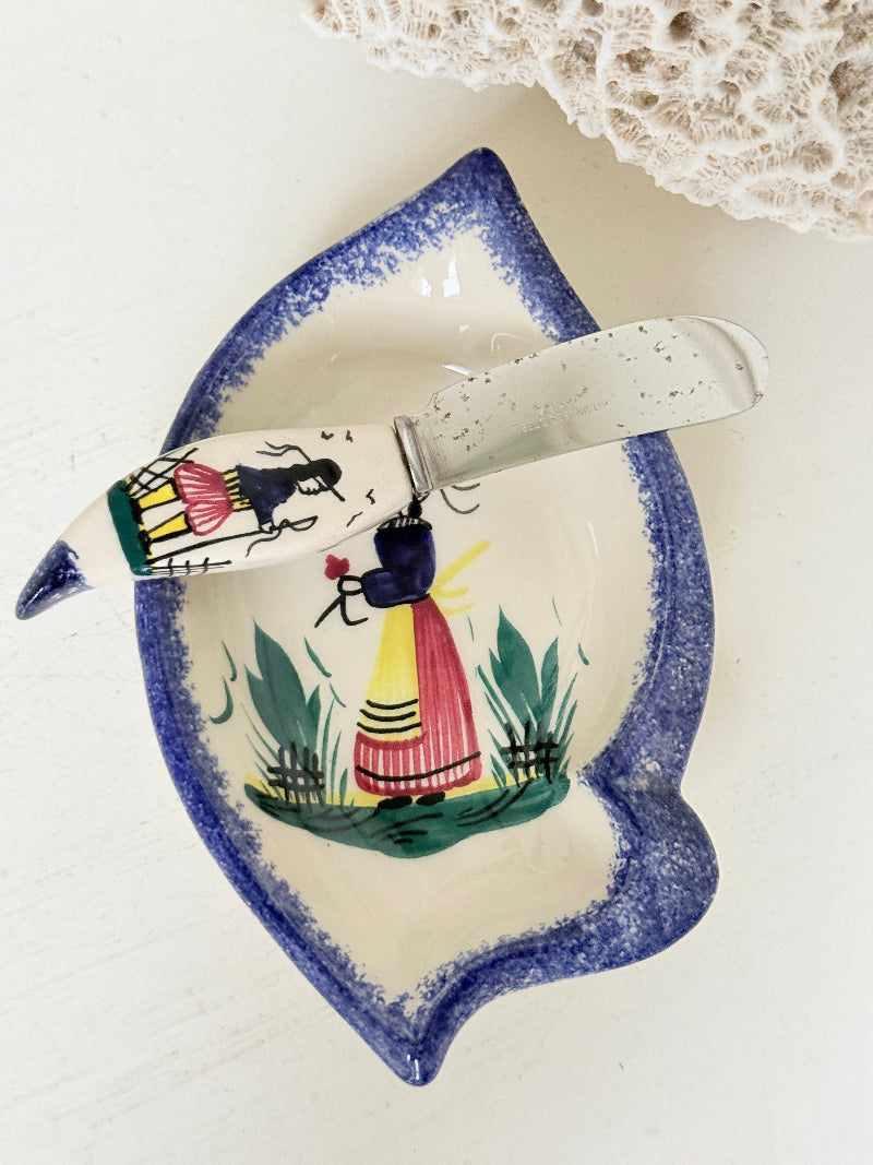 Vintage Quimper butter dish with ceramic knife, hand painted Breton figure, photographed on a white surface
