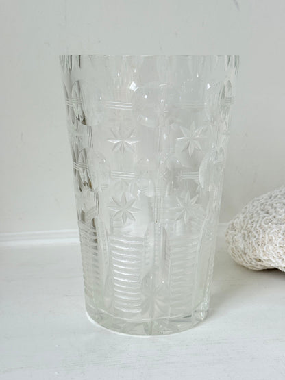 Vintage Stuart crystal cut glass vase with floral and star design, photographed on a white surface.
