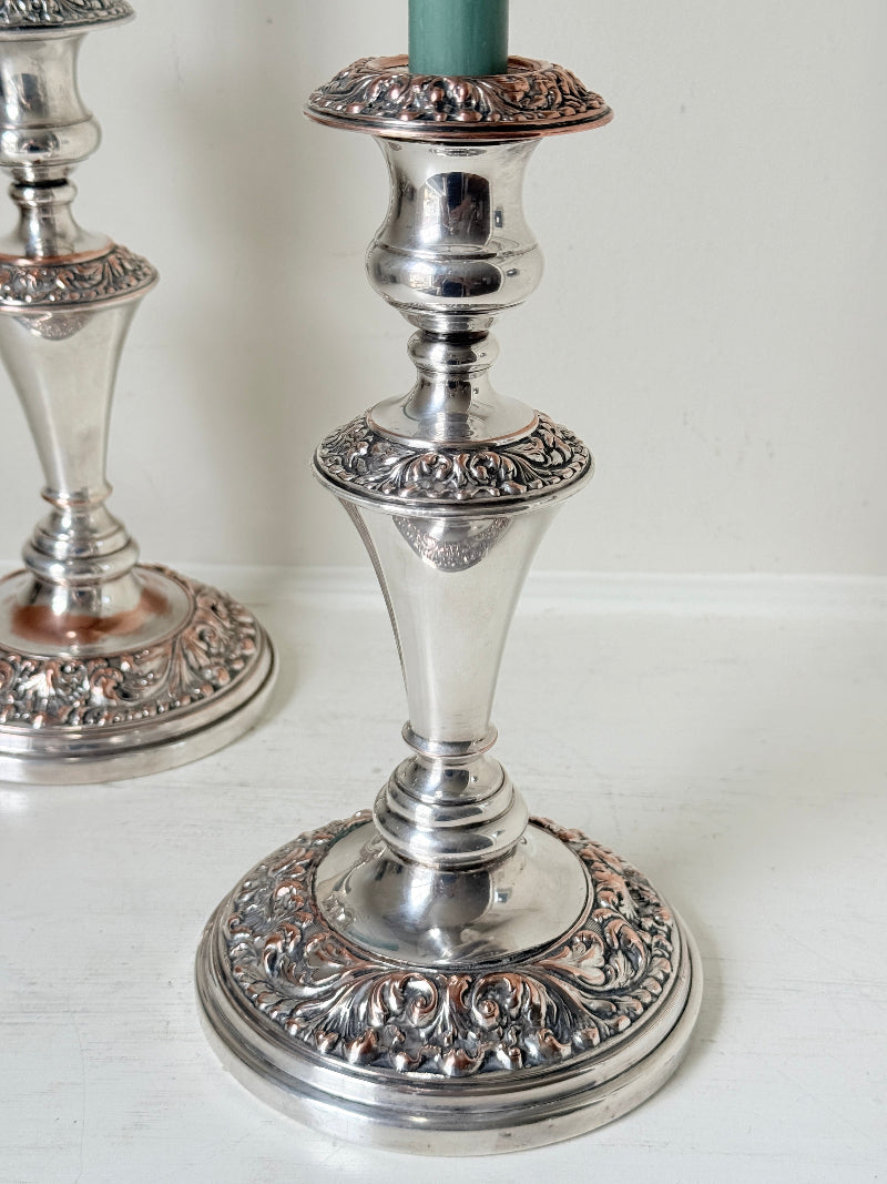 Pair of convertible silver plate on copper candelabra with repoussé detail, removable arms and green taper candles
