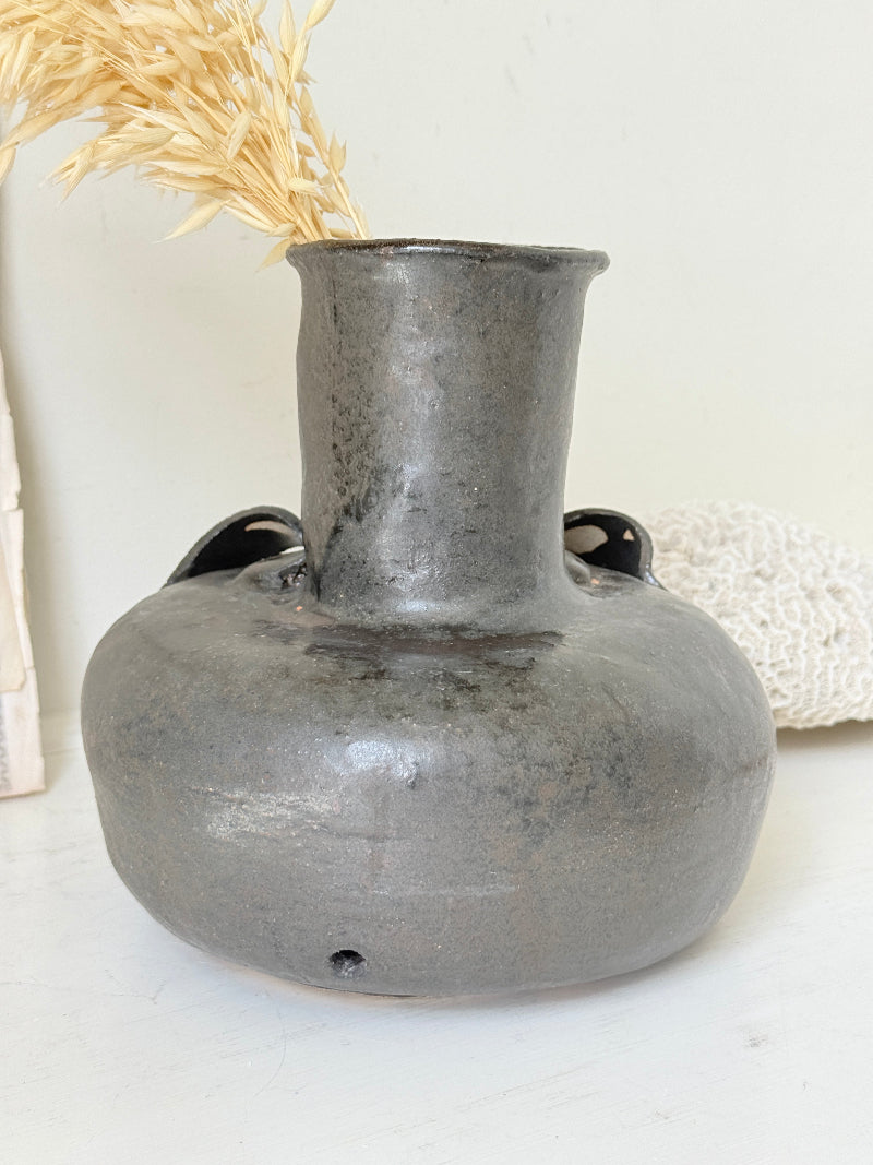 Studio pottery ceramic vase with liquorice grey glaze, applied floral and leaf detail and rounded handmade form