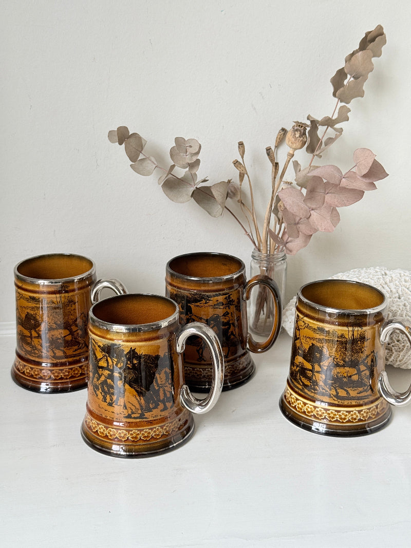 Set of 4 large Ridgways stoneware beer tankards photographed on a white surface in amber treacle glaze with black Coaching Days and Coaching Ways transfer scenes