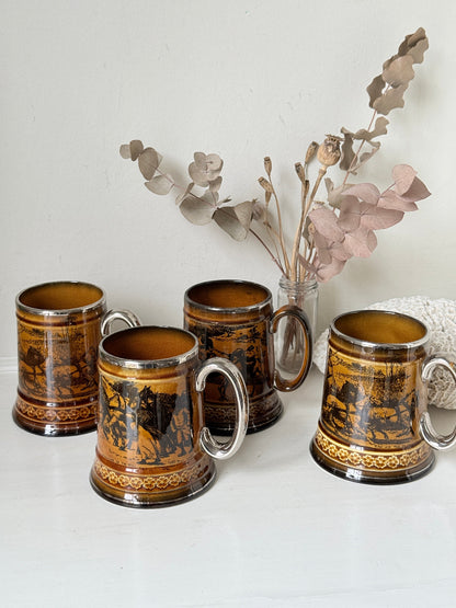 Set of 4 large Ridgways stoneware beer tankards photographed on a white surface in amber treacle glaze with black Coaching Days and Coaching Ways transfer scenes