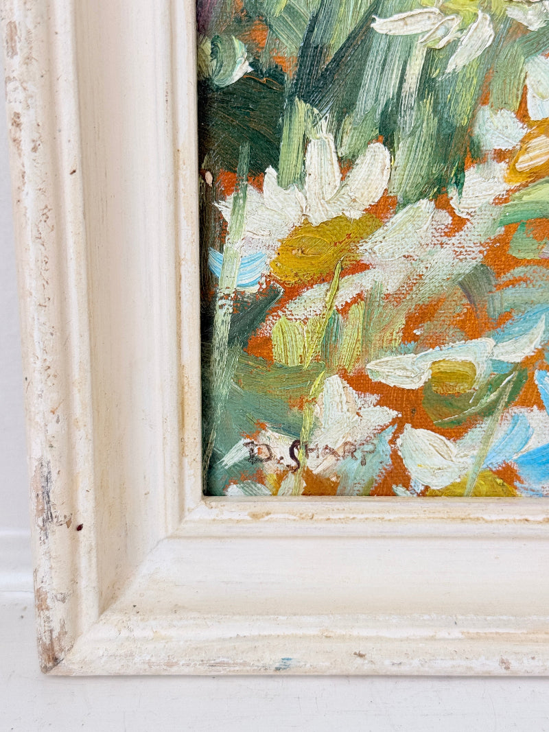 Oil painting after Dorothea Sharp of a young girl picking white flowers in a meadow, distressed white wood frame