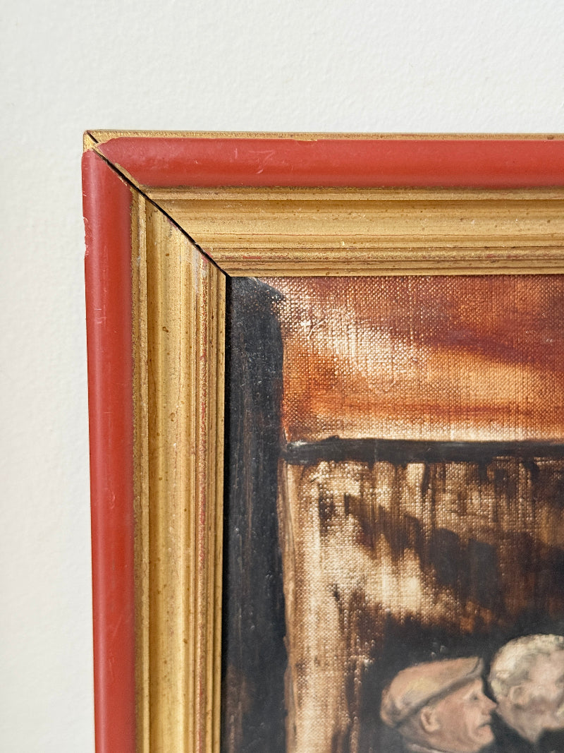 Close-up of a framed painting corner showing a red outer frame, a gold inner frame, and part of the painted scene with warm brown and black tones.