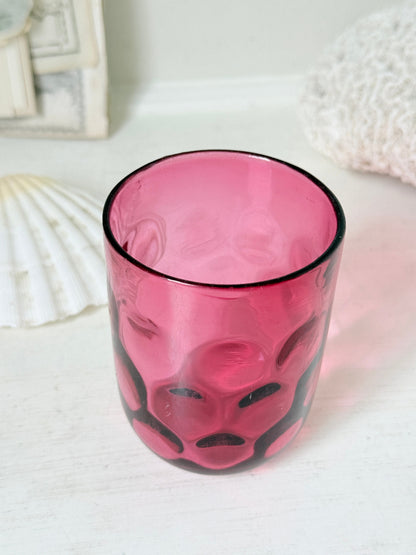 Vintage cranberry glass beaker with honeycomb optic pattern, deep pink colour and textured moulded glass for shelf styling