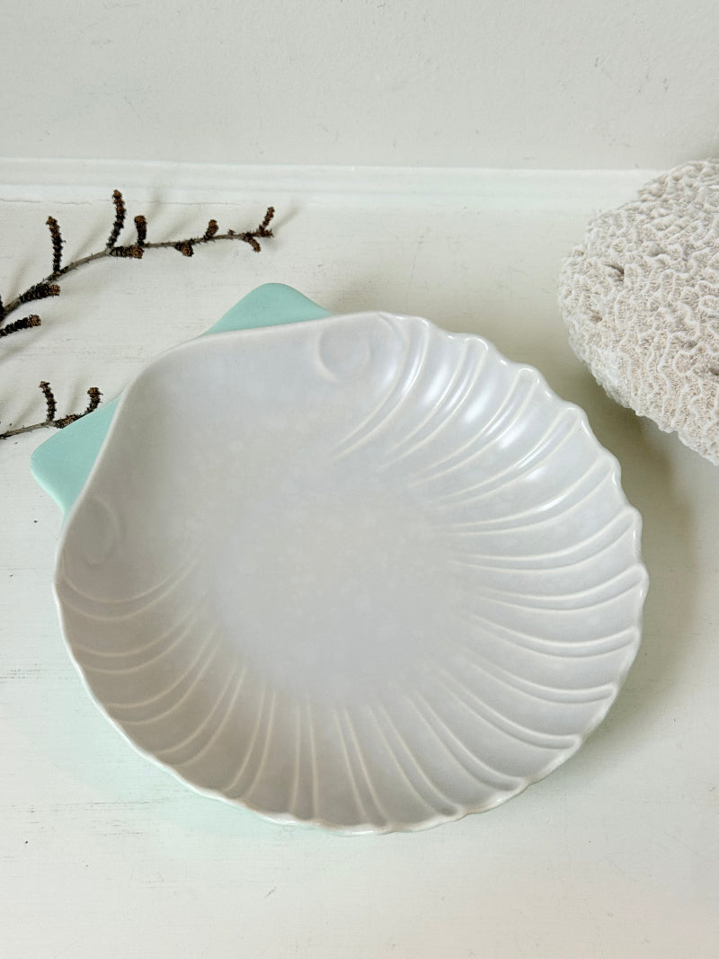 Poole Pottery scallop shell serving dish in white and seafoam glaze photographed on a white surface