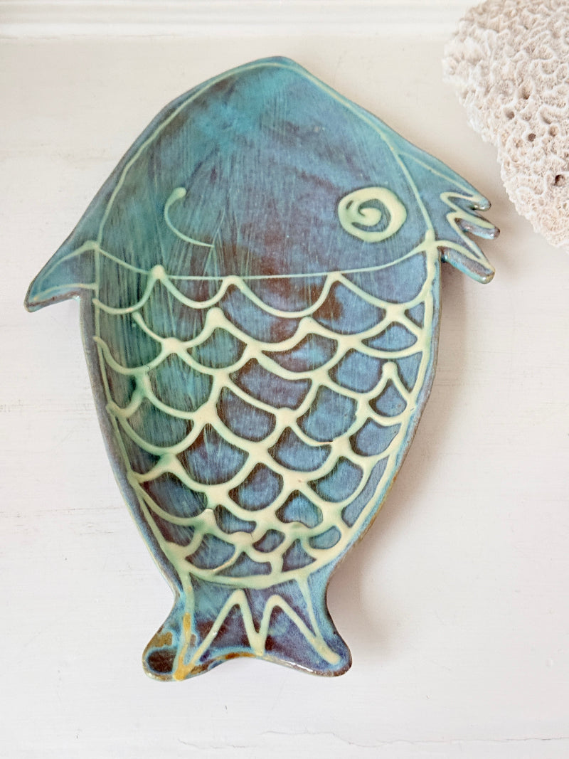 Barbados studio pottery fish platter in turquoise and sea green glaze photographed on a white surface