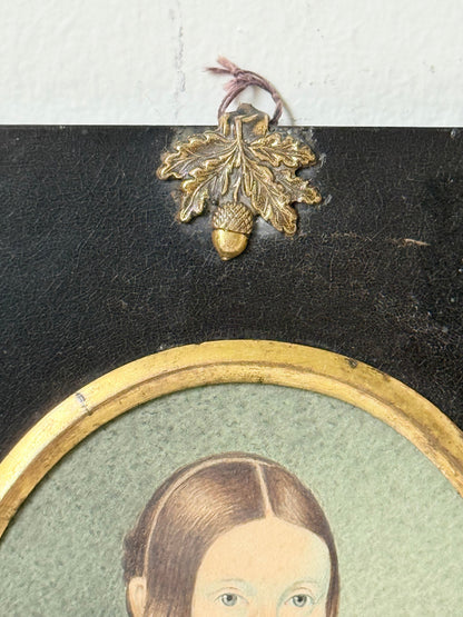 19th century watercolour miniature portrait of woman in blue dress, oval ebonised frame, styled on white background