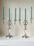 Pair of convertible silver plate on copper candelabra with repoussé detail, removable arms and green taper candles