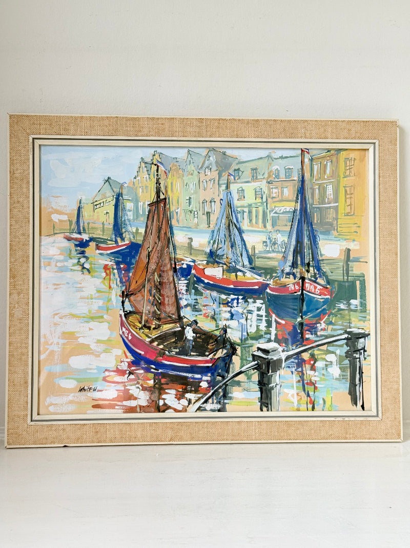 Mid century harbour scene painting with pastel boats and buildings, in wooden frame, photographed on a white surface