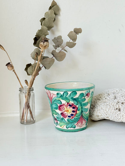 Italian handmade pot with colourful floral decoration, glazed finish, marked base, photographed on white surface.