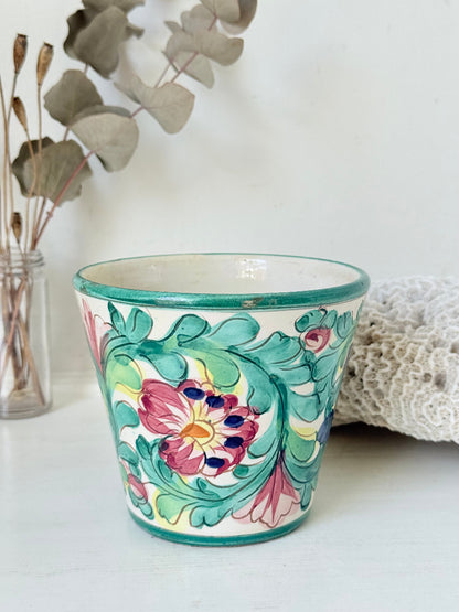 Italian handmade pot with colourful floral decoration, glazed finish, marked base, photographed on white surface.
