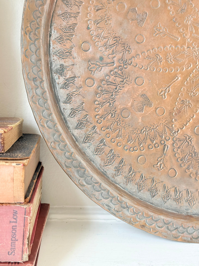 Vintage hand engraved copper tray with sunburst centre, decorative border and aged verdigris patina for wall or tabletop styling