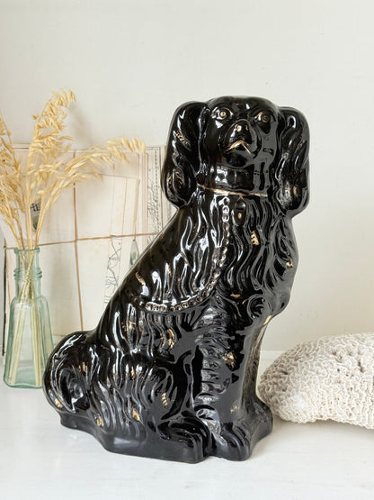 Vintage Staffordshire style black ceramic spaniel dog with gold lustre collar, glossy glaze and textured coat detail