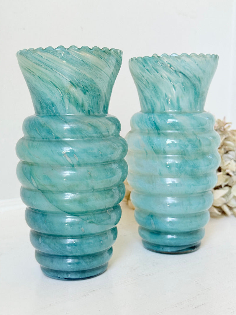 Pair of vintage aqua blue glass vases with beehive pattern and scalloped edges, photographed on a white surface