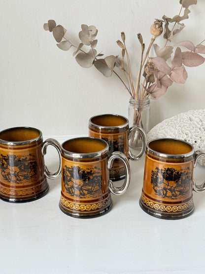 Set of 4 Ridgways stoneware tankard mugs photographed on a white surface in amber brown treacle glaze with black Coaching Days and Coaching Ways transfer scenes