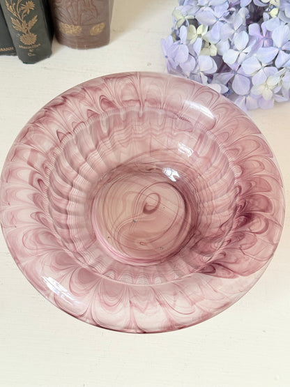 Davidson Cloud Glass bowl in amethyst with swirl pattern and footed base, styled with books and hydrangeas